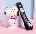 Snoopy 3D PVC keychain with black Snoopy wrist strap on pink background