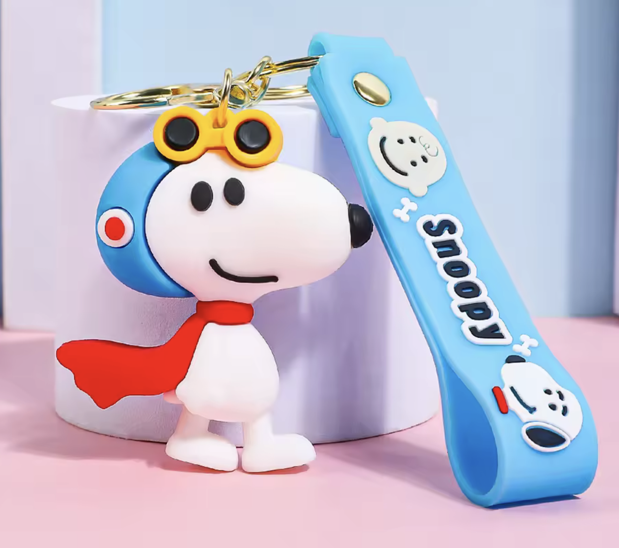 Snoopy pilot 3D PVC keychain with blue helmet yellow goggles and red scarf with blue Snoopy wrist strap