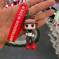 Mad Hatter 3D PVC keychain holding teacup with red Alice in Wonderland wrist strap, held in hand