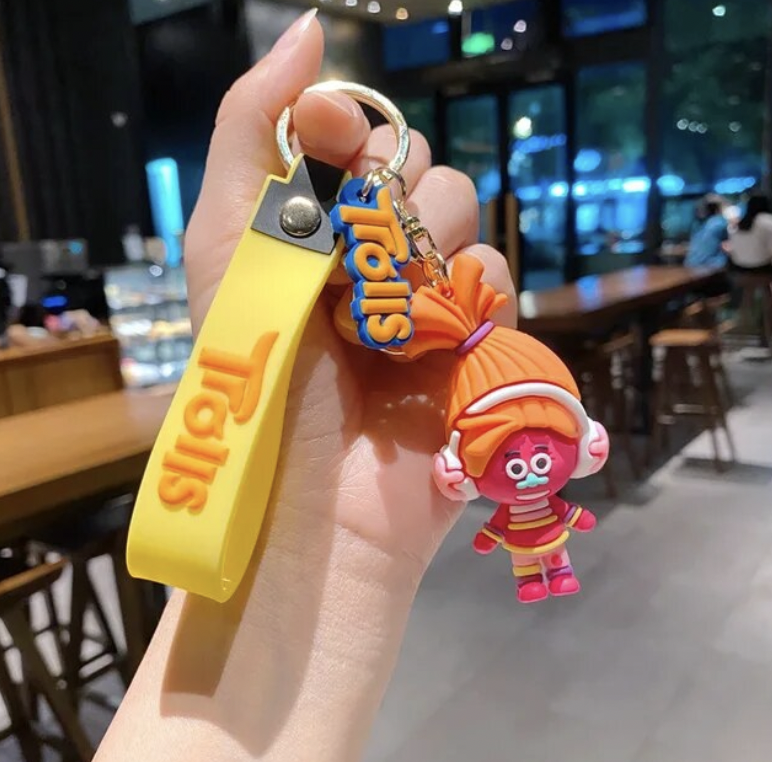 Orange Trolls character keychain with yellow silicone strap