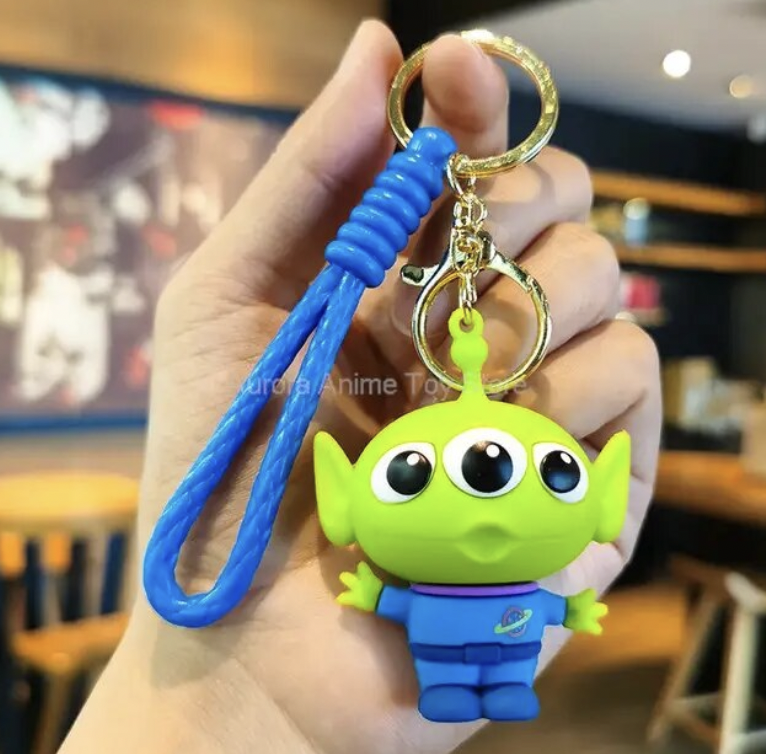 Little Green Alien 3D PVC keychain with blue wristlet strap and gold-tone lobster clasp