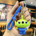 Toy Story Little Green Alien 3D PVC keychain held in hand showing three-eyed alien figure with blue cord