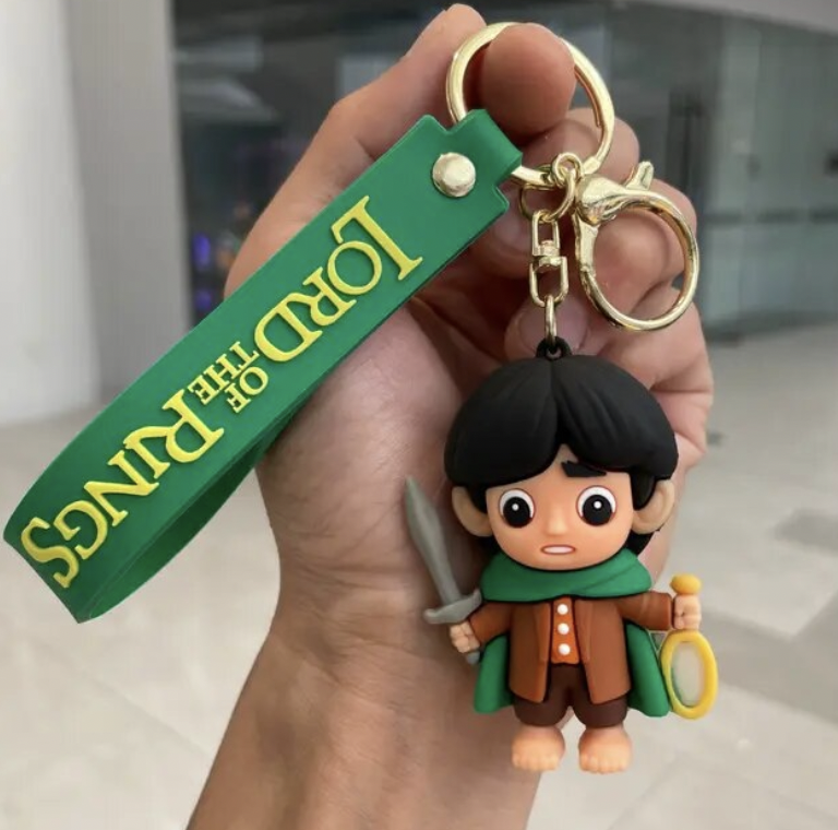 Lord of the Rings Frodo Baggins chibi keychain holding the One Ring and Sting with green wrist strap