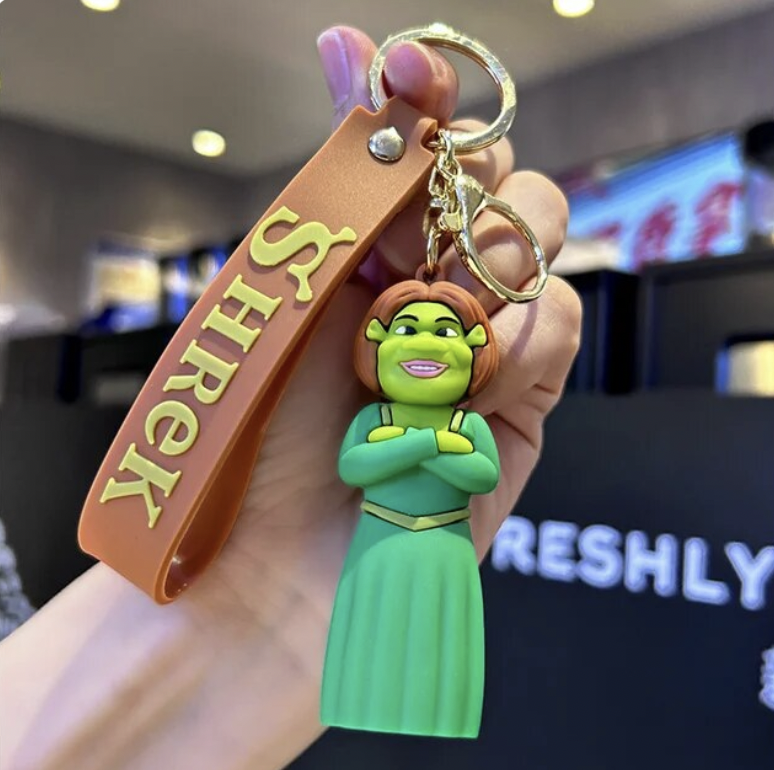 Princess Fiona Shrek 3D PVC keychain with brown Shrek branded wrist strap, held in hand